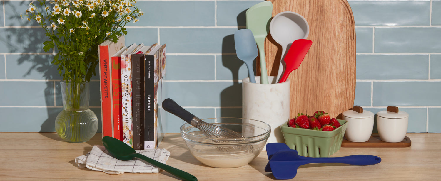 Different GIR Tools on a wooden kitchen counter, with books and a vase on the left. 