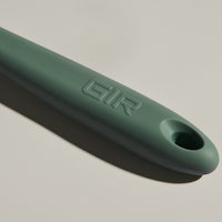 The GIR Sage Green Spatula handle on a grey background.