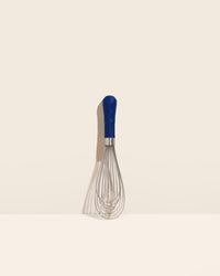 The Navy Ultimate Whisk on a cream background. 