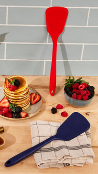The GIR Ultimate Turner in Red and Navy on a counter top with Pancakes and a bowl of berries next to it. 