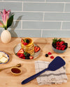 The GIR Ultimate Turner in Navy on counter top with Pancakes and berries next to it. 