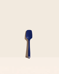 The Navy Ultimate Spoonula on a cream background. 